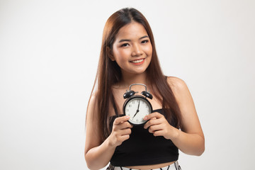 Young Asian woman smile with a clock.