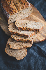 Rye bread with sunflower seeds on a wooden cutting board.