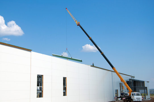 Sandwich panels at the construction site. Material for warming the walls of the building. Technologies in construction. An alternative to a brick building.
