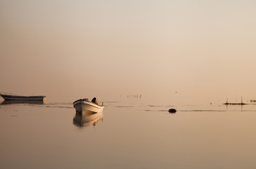 A boat during Sunrise at Asker beach with beautiful reflection on water
