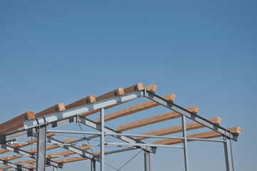 Wooden beams on steel structure for further construction. Metal frame for the installation of insulation panels. Construction of pre-fabricated buildings.