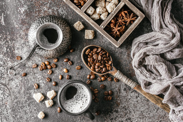 Coffee cup and coffee beans on dark stone background.