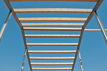 Wooden beams on steel structure for further construction. Metal frame for the installation of insulation panels. Construction of pre-fabricated buildings.