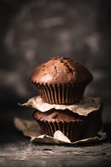 Sweet muffins with on dark textured background.