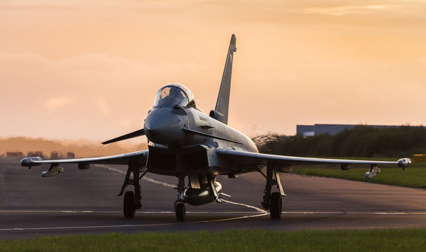 Backlit Typhoon taxis out for takeoff