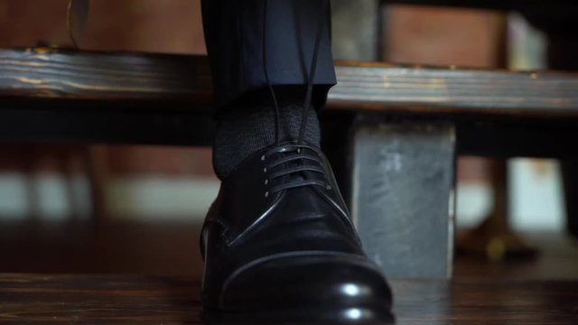 Man put on black shoes