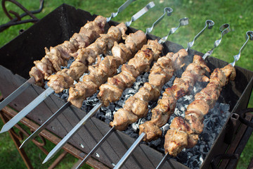 Shashlik pork on skewers.  Meat roasted on an open fire on the grill. Nature. Selective focus. 