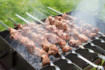Shashlik pork on skewers.  Meat roasted on an open fire on the grill. Nature. Selective focus. 