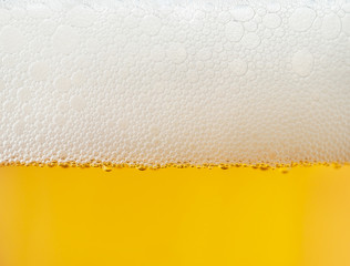 beer bubbles in a glass of fresh amber beer