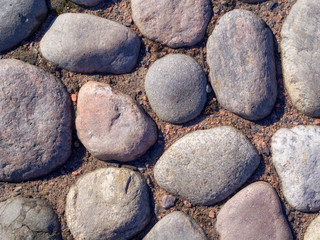 Historic cobblestone pavement, top view, stone road texture