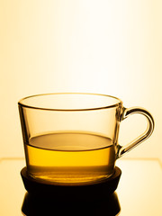 green tea in a glass cup on a cream color background