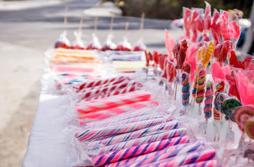 Close-up of colorful sugar sticks, sweet temptation in bright, fresh colors, sugary aromas, on a street market.