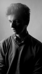 portrait of a young man with great hair, black and white, hard light cut