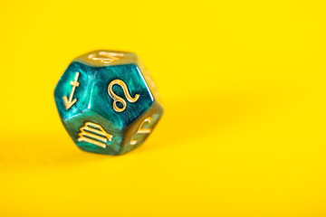 Astrology Dice with zodiac symbol of Leo Jul 23 - Aug 22 on Yellow Background