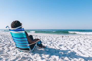 Black woman relaxing on the beach
