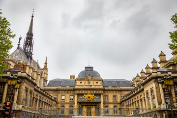 Fototapeta na wymiar Palais de Justice with people on square next building in Paris, France