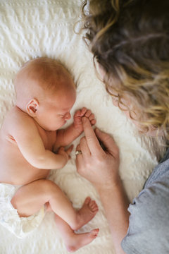 Mom and baby on bed