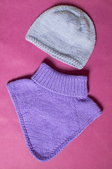 Flat lay woolen winter clothing. Top view sweater and hat.