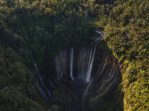 huge waterfall in tropical lush jungle from above