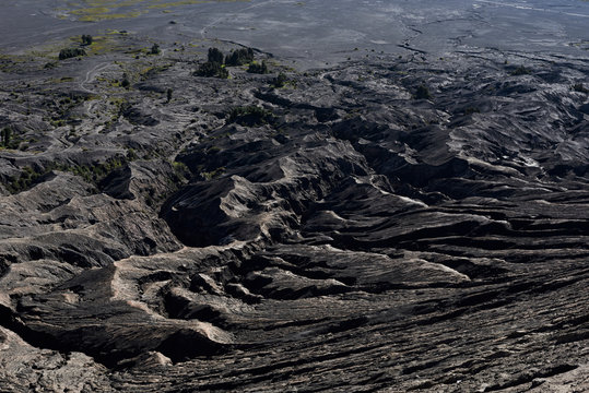 Rocky lava landscape view from the top of active volcano Mount Bromo.