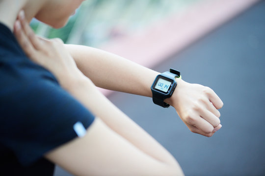 Sportswoman is measuring pulse while touching neck