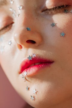 Portrait of woman with silver stars on face