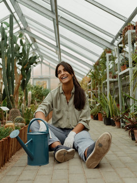 Laughing woman on walkway in greenhouse