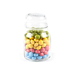 Colorful sweet candies in glass jar isolated on white.