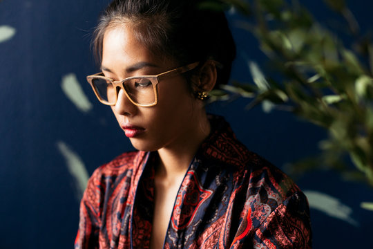 Asian young woman in wooden glasses