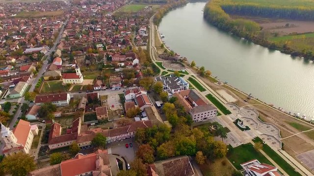 Aerial view of calm Tisa river and Novi Becej town in Serbia during autumn. 2018