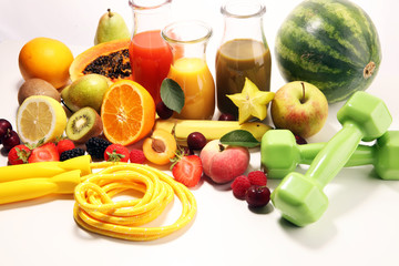 Healthy lifestyle concept. healthy fruits, smoothies and sport fitness equipment, dumbbells and jumping rope