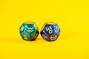 Astrology Dice with zodiac symbol of Aquarius Jan 20 - Feb 18 and its ruling planet Uranus on Yellow Background