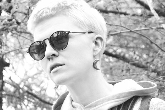 Portrait of a young fashionable girl in black sunglasses