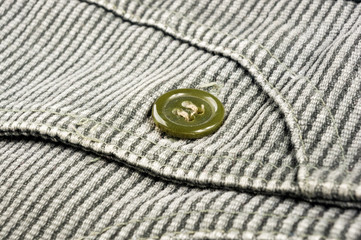 clothing items stonewashed cotton fabric texture with seams, clasps, buttons and rivets, macro