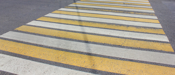 Pedestrian crosswalk on city road with zebra pattern to safely cross the street. Empty crosswalk banner with no people 