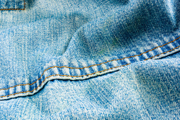clothing items blue stonewashed faded jeans cotton fabric texture with seams, clasps, buttons and...