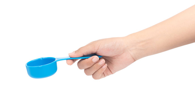 hand holding blue plastic scoop isolated on white background