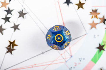 Astrology Dice with symbol of the Sun on Natal Chart Background