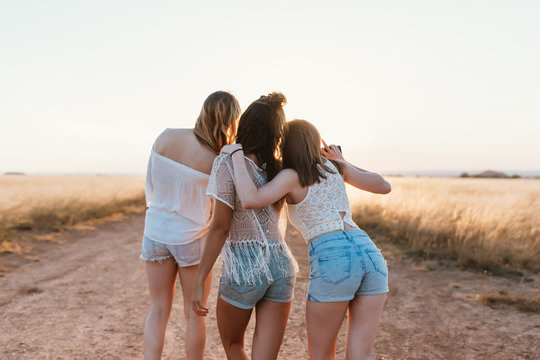Portraits from back of three girls.