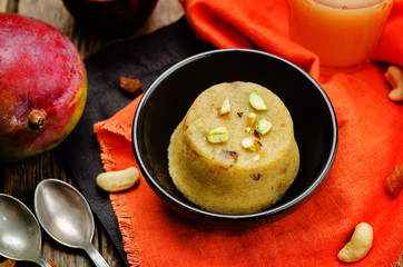 Indian Sooji mango Halwa on a wood background