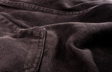 clothing items stonewashed cotton fabric texture with seams, clasps, buttons and rivets, macro