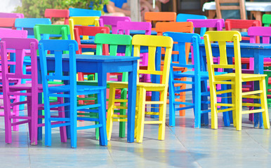 Colorful wooden chairs in mediterranean style stand outdoors. 