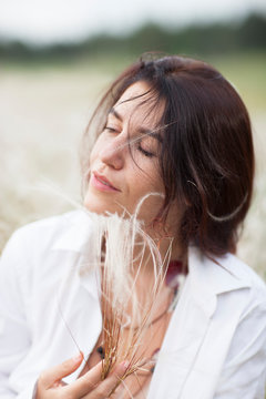 Sexy beautiful young woman relaxing in the park on a sunny day