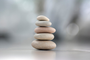 Harmony and balance, cairns, simple poise pebbles on wooden light white gray background, simplicity...