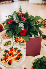boho wedding decor. festive table with burgundy tablecloth. decoration of the hall garland with light bulbs.