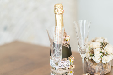 Wedding ceremony. Wedding glasses with champagne, flowers. Wedding ring. Wedding rings and glasses and bottle of champagne. 