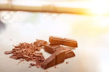 Pieces of delicious chocolate isolated on white