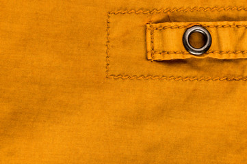 clothing items stonewashed cotton fabric texture with seams, clasps, buttons and rivets, macro