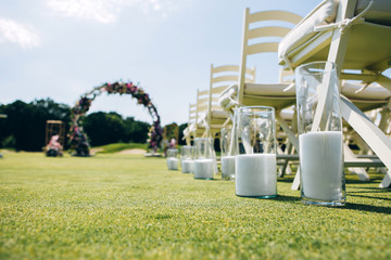 wedding ceremony in nature. Rows of white chairs on the lawn.