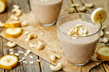cashew banana cocoa oats smoothie on a wood background